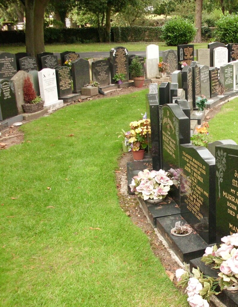 Two tightly-packed rows of headstones for cremated remains